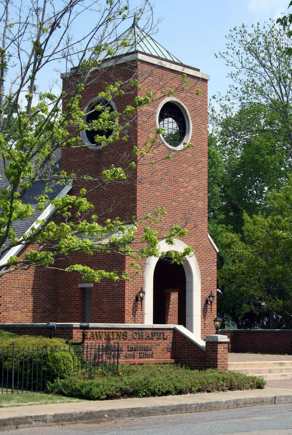  The exterior of Hawkins Chapel, a brick building with a small bell tower. 